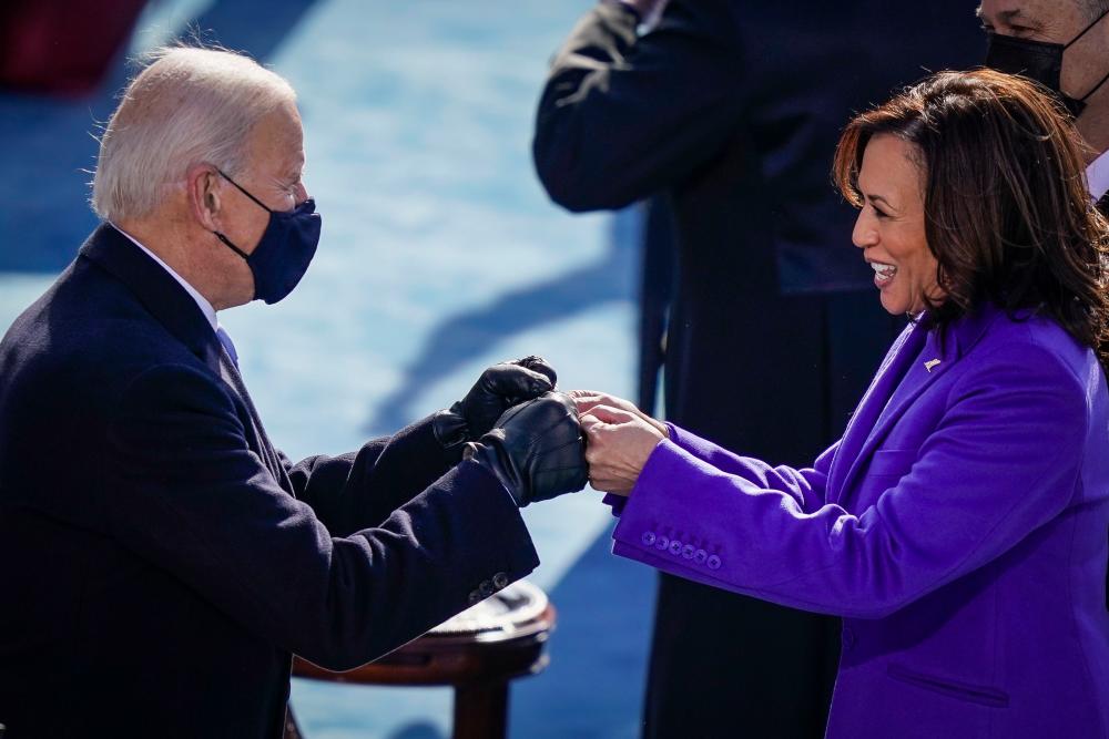 U.S. President-elect Joe Biden fist bumps newly sworn-in Vice President Kamala Harris after she took the oath of office on the West Front of the U.S. Capitol on January 20, 2021 in Washington, DC. -Drew Angerer/Getty Images/AFP