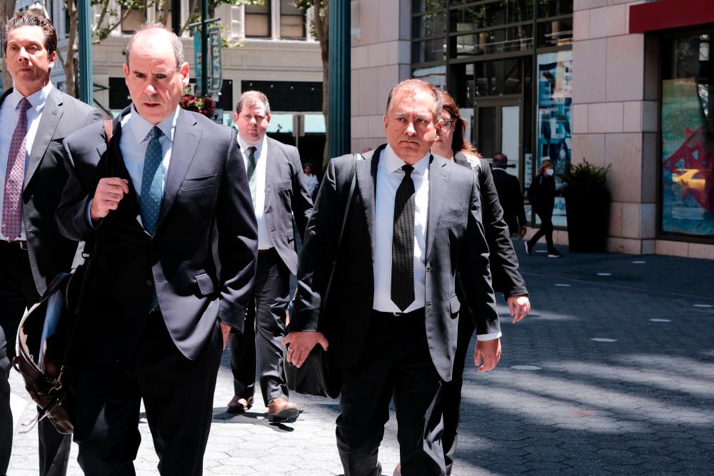 SAN JOSE, CA - JULY 07: Former Theranos COO Ramesh “Sunny” Balwani and his legal team leave the Robert F. Peckham Federal Building on July 7, 2022 in San Jose, California. AFPPIX