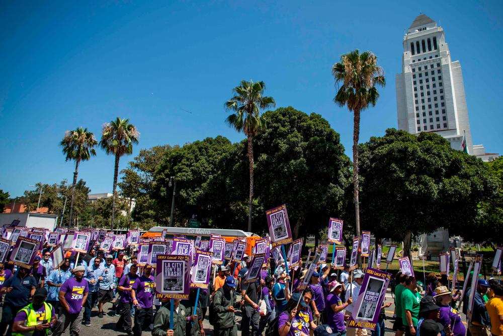 LOS ANGELES, CALIFORNIA - AUGUST 8: LA City workers rally in front of the Los Angeles City Hall Building in Downtown during a 1-day walked-off job strike to protest contract negotiations on August 8, 2023 in Los Angeles, California. - AFPPIX