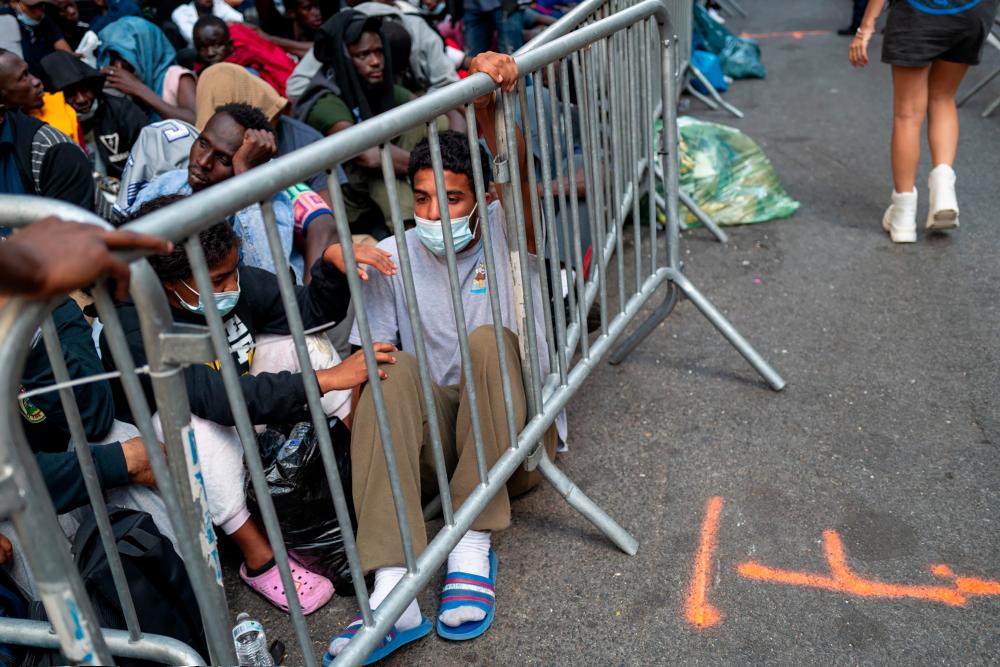 NEW YORK, NEW YORK - AUGUST 01: Dozens of recently arrived migrants to New York City camp outside of the Roosevelt Hotel, which has been made into a reception center, as they try to secure temporary housing on August 01, 2023 in New York City. - AFPPIX