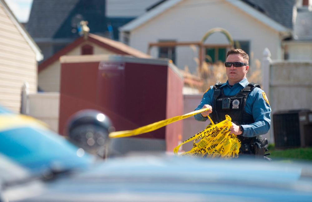 Police officers from the Falls Township Police Department tape off and inspect the scene of one of three shootings in the Vermillion Hills neighborhood on March 16, 2024 in Levittown, Pennsylvania/AFPPix