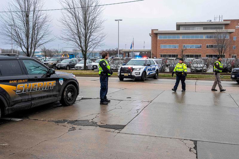 Law enforcement stand near a health care clinic where students from Abundant Life Christian School will be reunited withe their parents after a school shooting on December 16, 2024 in Madison, Wisconsin. AFPpix