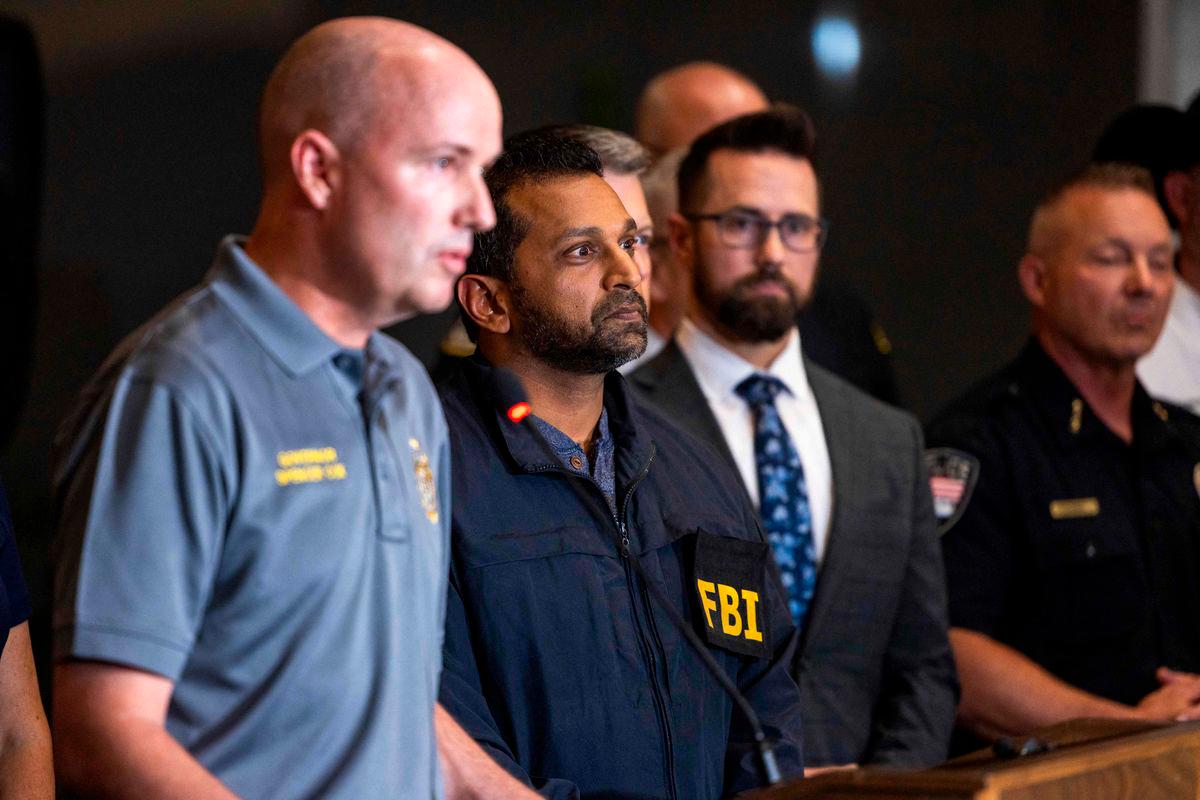 FBI director Kash Patel, right, listens as Governor of Utah Spencer Cox speaks during a press conference at Utah Valley University on September 11, 2025 in Orem, Utah. Authorities have released a “person of interest” as they search for the suspect who shot and killed Kirk, founder of Turning Point USA, while he was speaking at an event for his “American Comeback Tour”. Michael Ciaglo/Getty Images/AFP (Photo by Michael Ciaglo / GETTY IMAGES NORTH AMERICA / AFP)