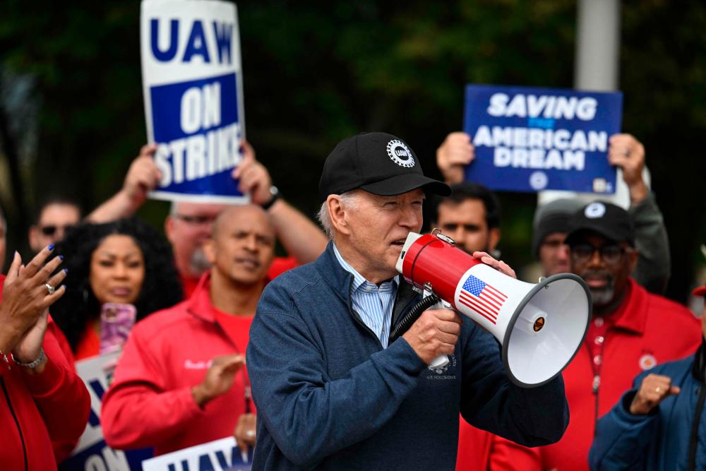 US President Joe Biden addresses striking members of the United Auto Workers (UAW) union at a picket line outside a General Motors Service Parts Operations plant in Belleville, Michigan, on September 26, 2023. AFPPIX