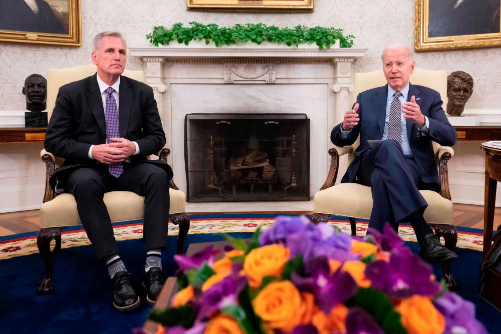 US House Speaker Kevin McCarthy (left) looks on as Biden speaks during a meeting on the debt ceiling, in the Oval Office of the White House in Washington, DC, on Monday, May 22, 2023. – AFPpic
