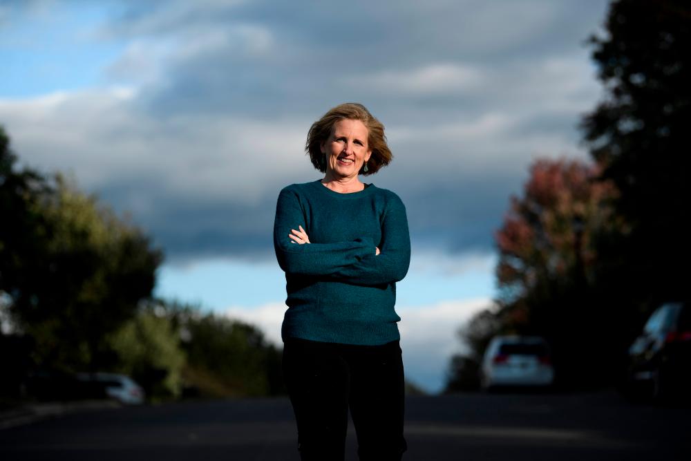 Juli Briskman, who was fired after giving US President Donald Trump's motorcade the middle finger while cycling and is running for a seat on the Loudoun County Board of Supervisors, poses Oct 17, 2019, in Sterling, Virginia. — AFP