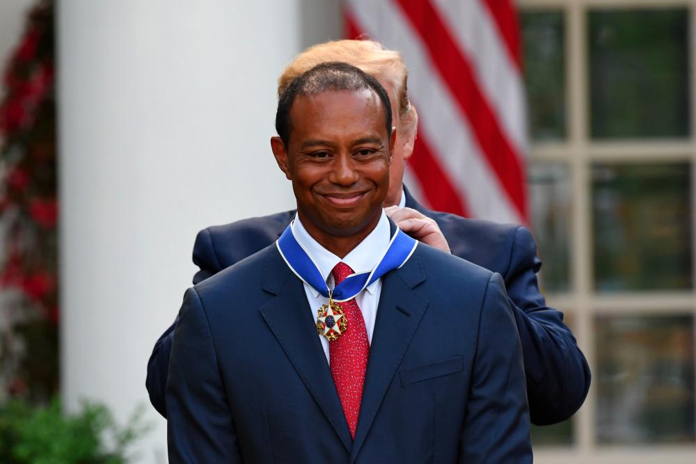US President Donald Trump presents US golfer Tiger Woods with the Presidential Medal of Freedom during a ceremony in the Rose Garden of the White House in Washington, DC, on May 6, 2019. - AFP