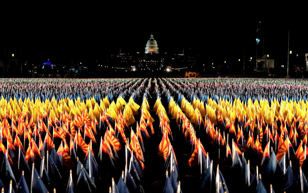 The “Field of Flags” is pictured on the National Mall as the US Capitol Building is prepared for the inauguration ceremonies for President-elect Joe Biden and Vice President-elect Kamala Harris on January 18, 2021 in Washington, DC. President-elect Joe Biden and Vice President-elect Kamala Harris will be sworn into office January 20, 2021. / AFP / TIMOTHY A. CLARY