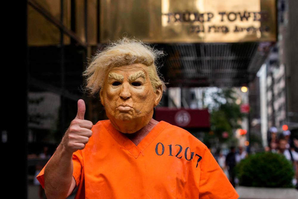 A protestor dressed up as former US President Donald Trump poses for photos outside Trump Tower in New York, New York, on August 10, 2022. AFPPIX