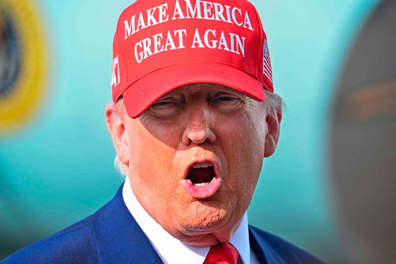 US President Donald Trump speaks to reporters after landing at the Palm Beach International Airport in West Palm Beach, Florida on February 16, 2025 after attending the Daytona 500 car race earlier in the day. - ROBERTO SCHMIDT / AFP