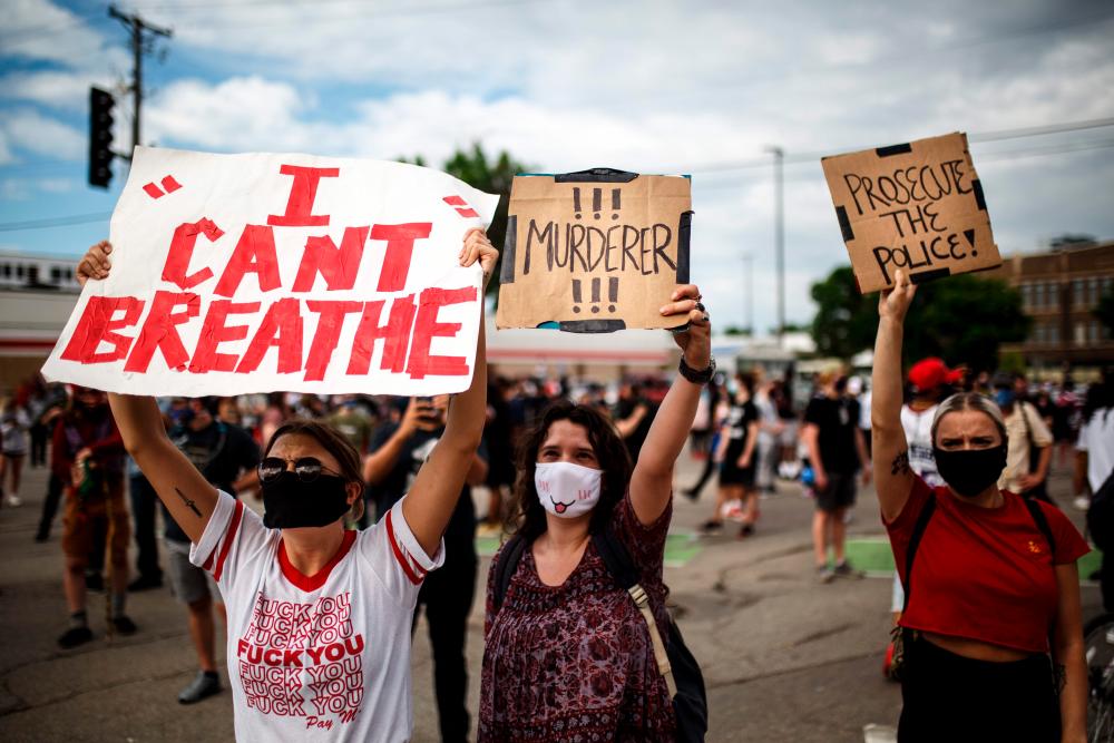 Protesters demonstrate in a call for justice for George Floyd following his death, outside the 3rd Police Precinct on May 27, 2020 in Minneapolis, Minnesota. — AFP