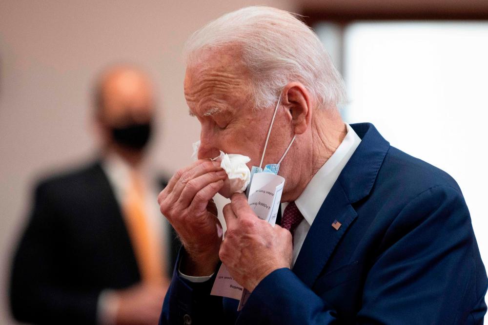 Former vice president and Democratic presidential candidate Joe Biden uses a tissues as he meets with clergy members and community activists during a visit to Bethel AME Church in Wilmington, Delaware on June 1, 2020. — AFP
