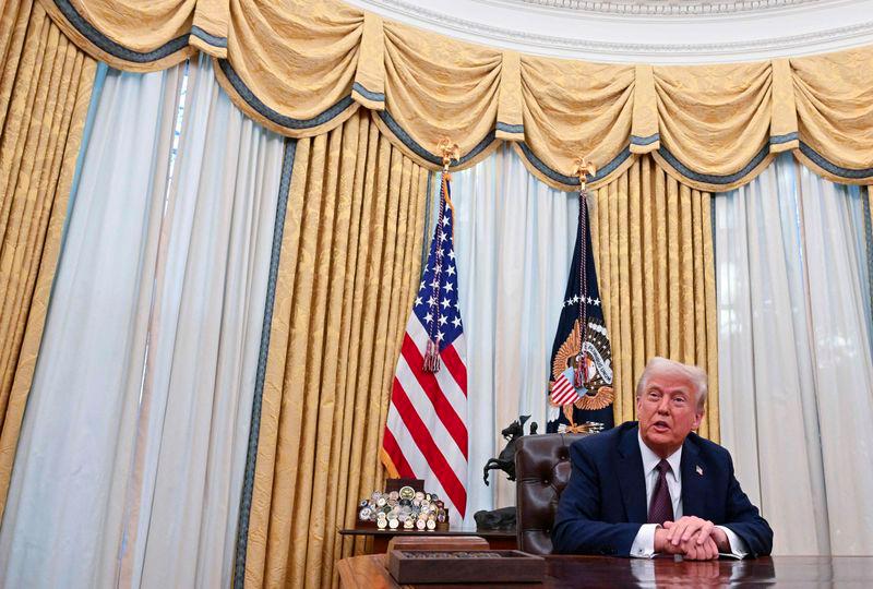 US President Donald Trump speaks to the media after he signed Executive Orders in the Oval office of the White House on January 23, 2025. - AFPPIX