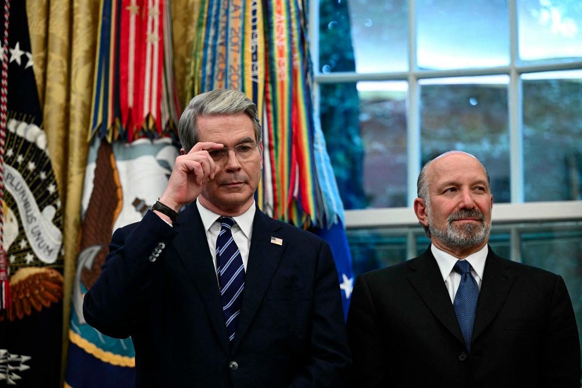 US Treasury Secretary Scott Bessent (L) and Commerce Secretary Howard Lutnick listen to President Donald Trump speak in the Oval Office of the White House in Washington, DC, on August 6, 2025 to announce Apple will invest an additional $100 billion in the United States, taking its total pledge to $600 billion over the next four years. - AFPPIX