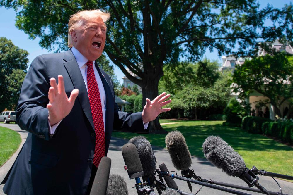 US President Donald Trump speaks with reporters at the White House in Washington, DC, on June 11, 2019. - AFP