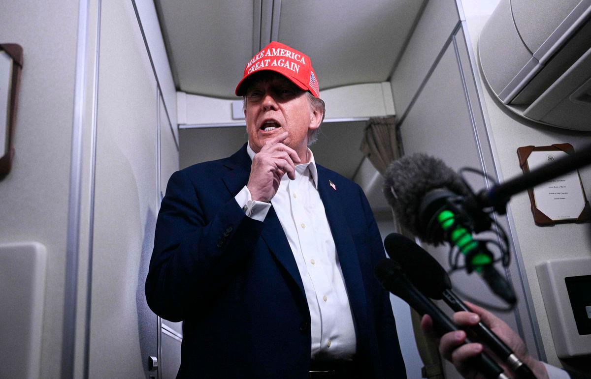 US President Donald Trump speaks to journalists aboard Air Force One after departing Joint Base Andrews, Maryland on his way to Bedminster - Brendan SMIALOWSKI / AFPPix