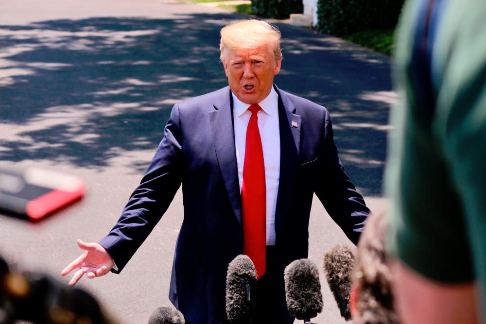 US President Donald Trump speaks to the press as he departs the White House in Washington, DC on June 26, 2019. — AFP