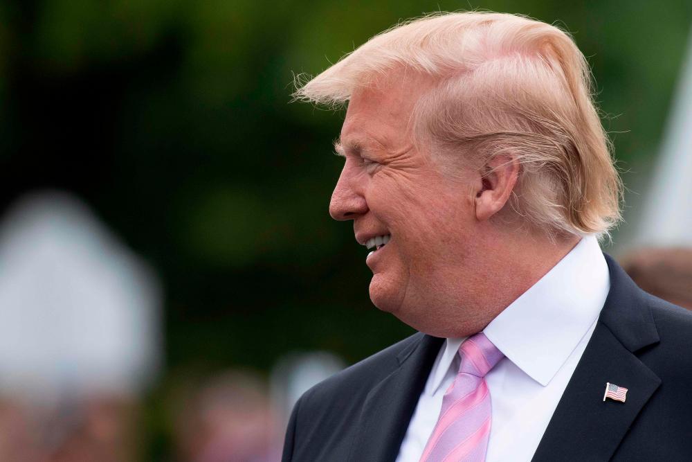 US President Donald Trump smiles during the annual White House Easter Egg Roll on the South Lawn of the White House in Washington, DC on April 22, 2019. — AFP