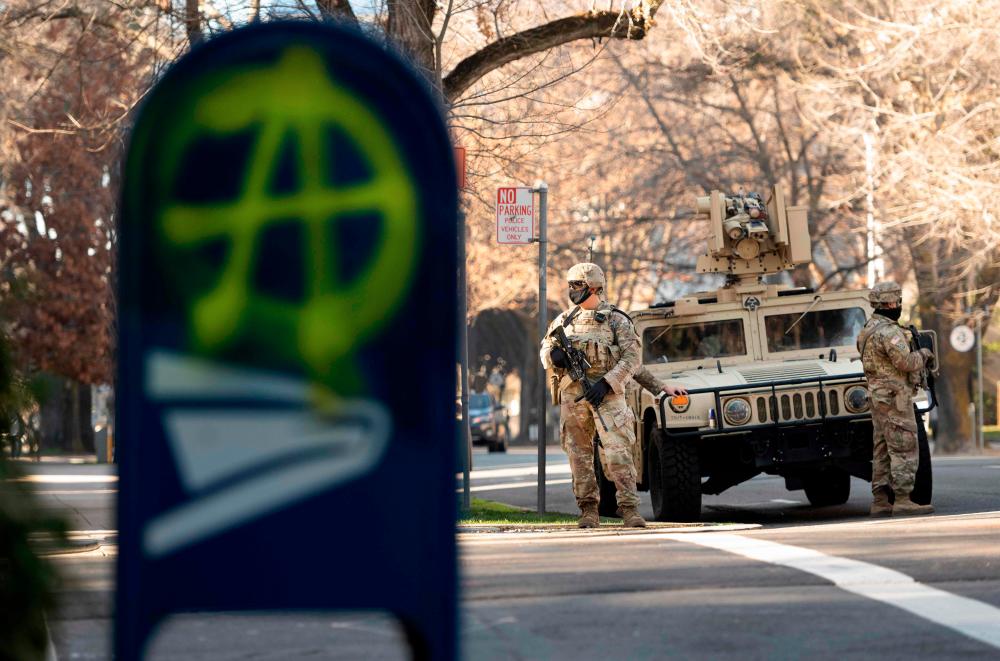 Members of the National Guard patrol near the State Capitol in Sacramento, California on January 17, 2021 during a nationwide protest called by anti-government and far-right groups supporting US President Donald Trump and his claim of electoral fraud in the November 3 presidential election. The FBI warned authorities in all 50 states to prepare for armed protests at state capitals in the days leading up to the January 20 presidential inauguration of President-elect Joe Biden. / AFP / JOSH EDELSON
