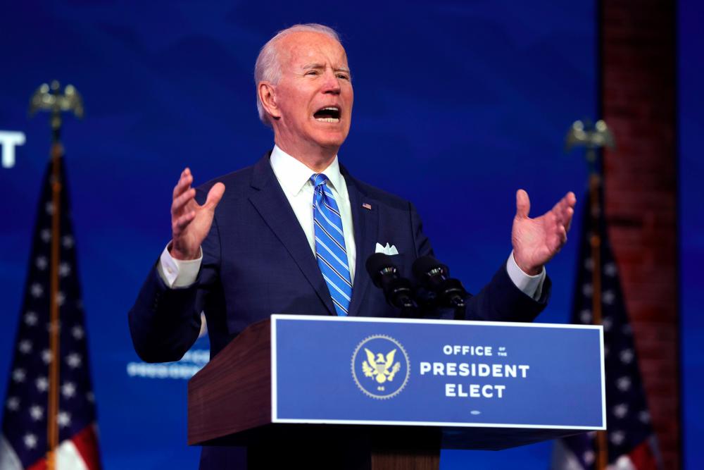 WILMINGTON, DELAWARE - JANUARY 14: U.S. President-elect Joe Biden speaks as he lays out his plan for combating the coronavirus and jump-starting the nation’s economy at the Queen theater January 14, 2021 in Wilmington, Delaware. Alex Wong/Getty Images/AFP