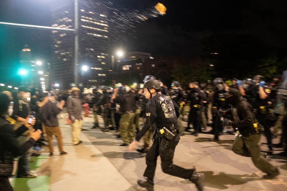 Protesters demonstrate during a night of clashes between protesters and Detroit Police Officers, violence returned to downtown Detroit as police made dozens of arrests and fired tear gas and rubber bullets at protesters on May 30, 2020 in Detroit, Michigan. — AFP