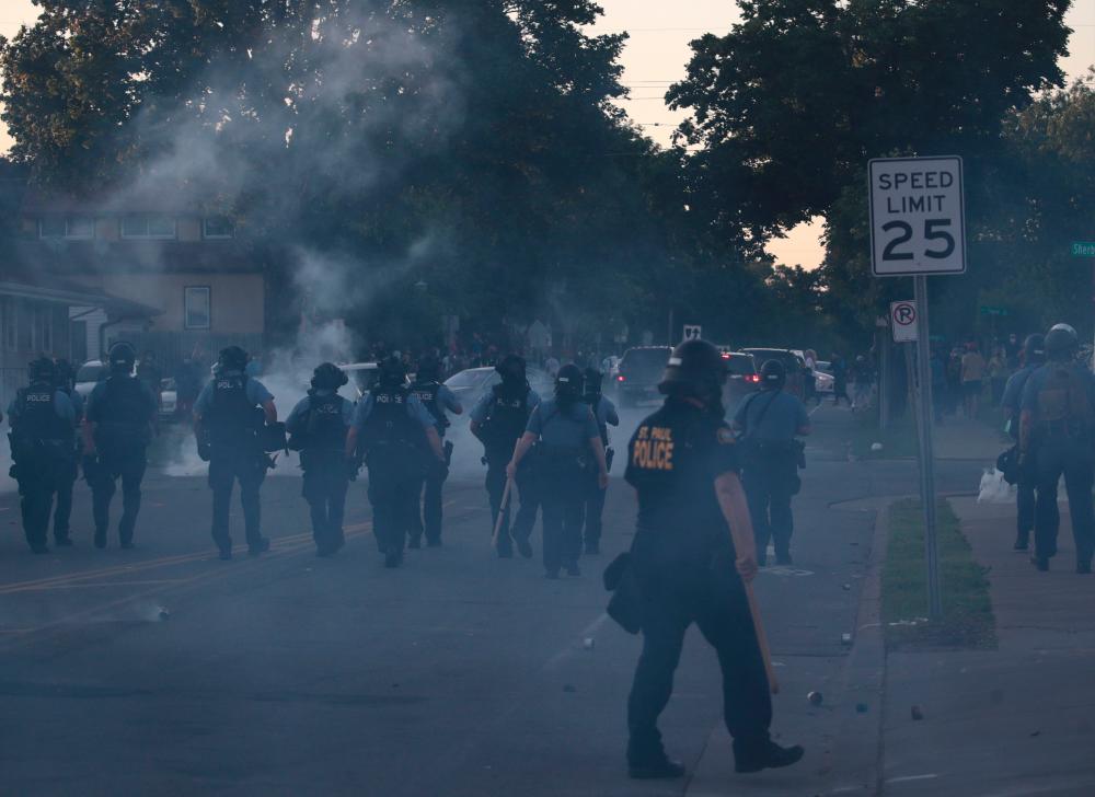 Police officers advance in a cloud of tear gas during a protest on May 28, 2020 in St. Paul, Minnesota. — AFP