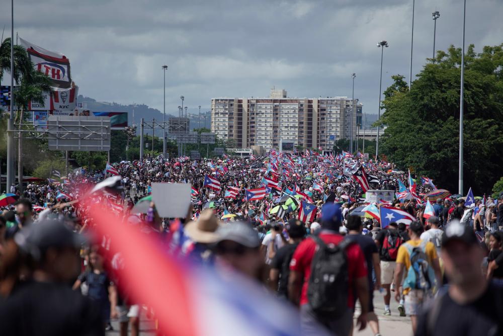 People take to the Las Americas Highway in San Juan, Puerto Rico, July 22, 2019 on day 9th of continuous protests demanding the resignation of Governor Ricardo Rosselló. — AFP