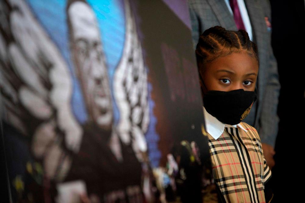Gianna Floyd, daughter of George Floyd, stands next to a podium during a news conference on the George Floyd Justice in Policing Act at the Mickey Leland Federal Building in downtown Houston, Texas on March 6, 2021. - AFP