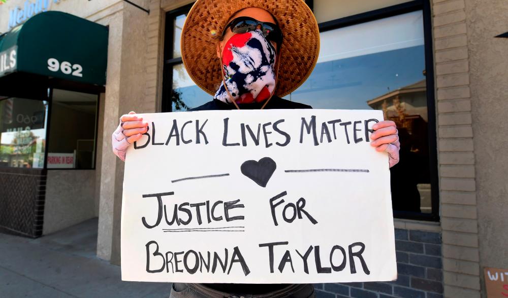 Activists protest on September 27, 2020 in La Canada Flintridge, California against the decision to not file criminal charges against three Louisville Kentucky police officers connected with the shooting death of Breonna Taylor. — AFP