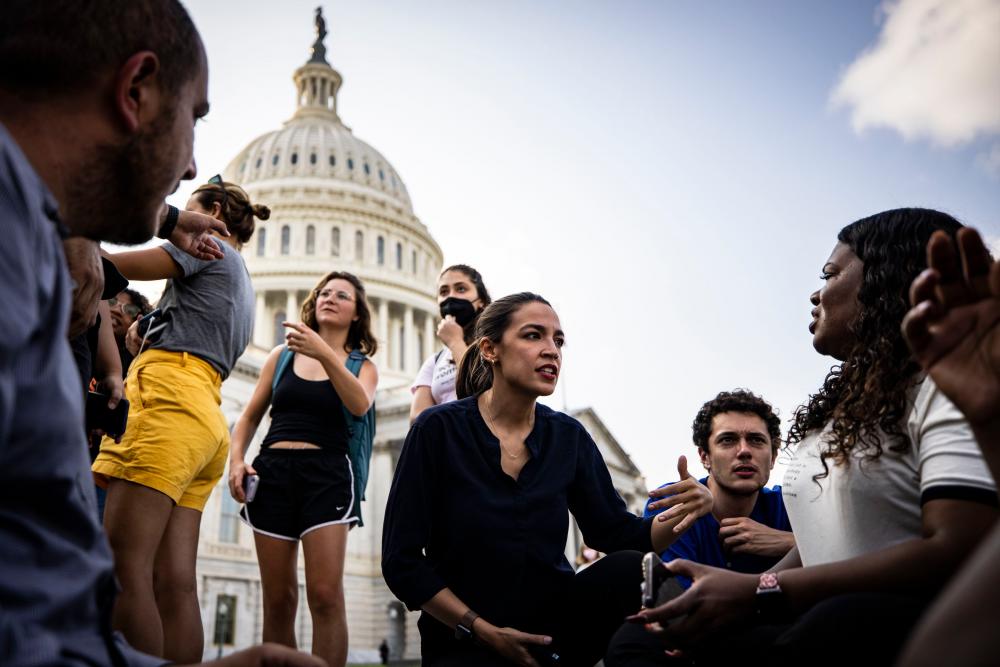 US Representatives Alexandria Ocasio-Cortez (D-NY) (center) and Cori Bush (D-MO) (right) continue their protest for an extension of the eviction moratorium on the steps to the House of Representatives at the U.S. Capitol Building on August 1, 2021 in Washington, DC. -AFP