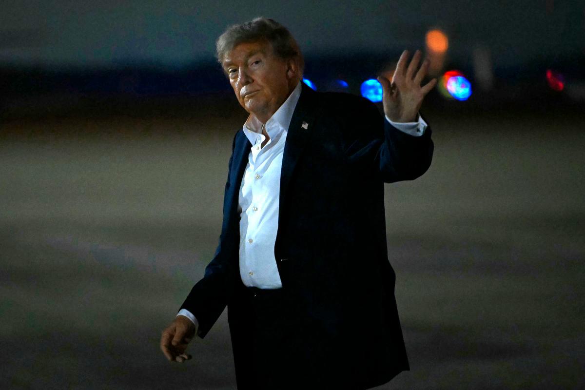 US President Donald Trump waves upon arrival at Joint Base Andrews in Maryland, on August 15, 2025. Donald Trump and Vladimir Putin made no breakthrough on Ukraine at their high-stakes summit on August 15, 2025, pointing to areas of agreement and rekindling a friendship but offering no news on a ceasefire. After an abrupt ending to three hours of talks with aides, Trump and Putin offered warm words but took no questions from reporters -- highly unusual for the media-savvy US president Photo by ANDREW CABALLERO-REYNOLDS / AFP