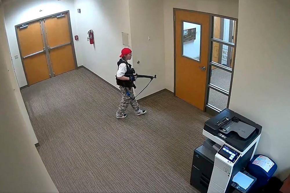 This handout video grab image courtesy of the Metropolitan Nashville Police Department released on March 27, 2023, shows suspect Audrey Hale holding an assault rifle at the Covenant School building at the Covenant Presbyterian Church, in Nashville, Tennessee. AFPPIX