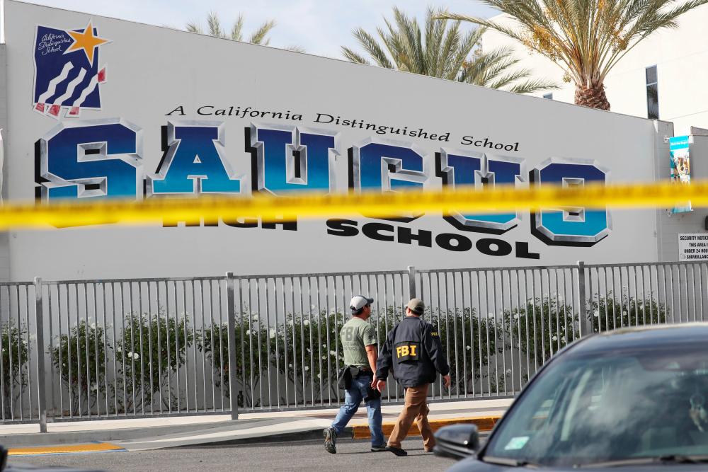 FBI personnel walk at Saugus High School after a shooting at the school left two students dead and three wounded on Nov 14, in Santa Clarita, California. — AFP