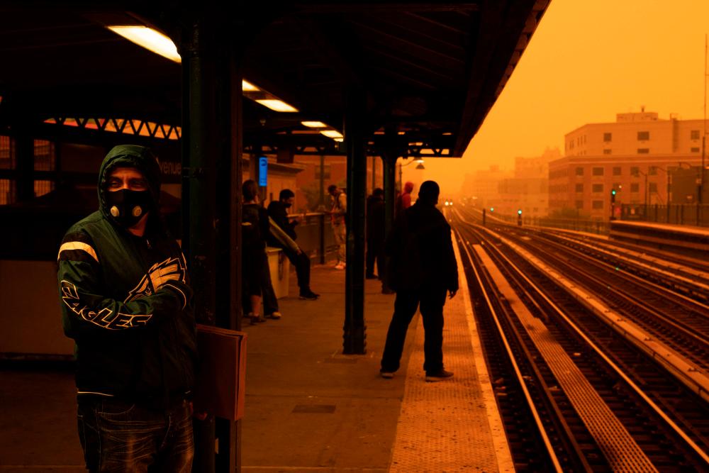 NEW YORK, NEW YORK - JUNE 7: A person waiting for the subway wears a filtered mask as smoky haze from wildfires in Canada blankets a neighborhood on June 7, 2023 in the Bronx borough of New York City. AFPPIX