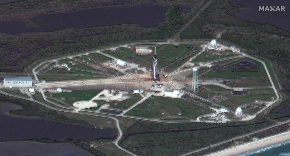This satellite image taken and released by Maxar Technologies on April 22, 2021 shows launch pad 39A, the Falcon 9 rocket and the Crew Dragon spacecraft at the Kennedy Space Center ahead of tomorrow morning's SpaceX Falcon 9 launch. A crewed SpaceX mission to the International Space Station was been postponed by a day due to weather concerns downrange of the launch site, NASA said on april 21. –AFP