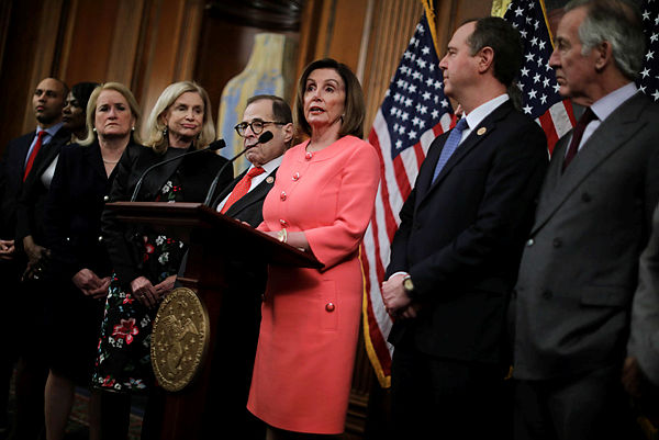 US Speaker of the House Nancy Pelosi (D-CA) (C) makes brief remarks before signing the articles of impeachment against President Donald Trump on Jan 15. — AFP