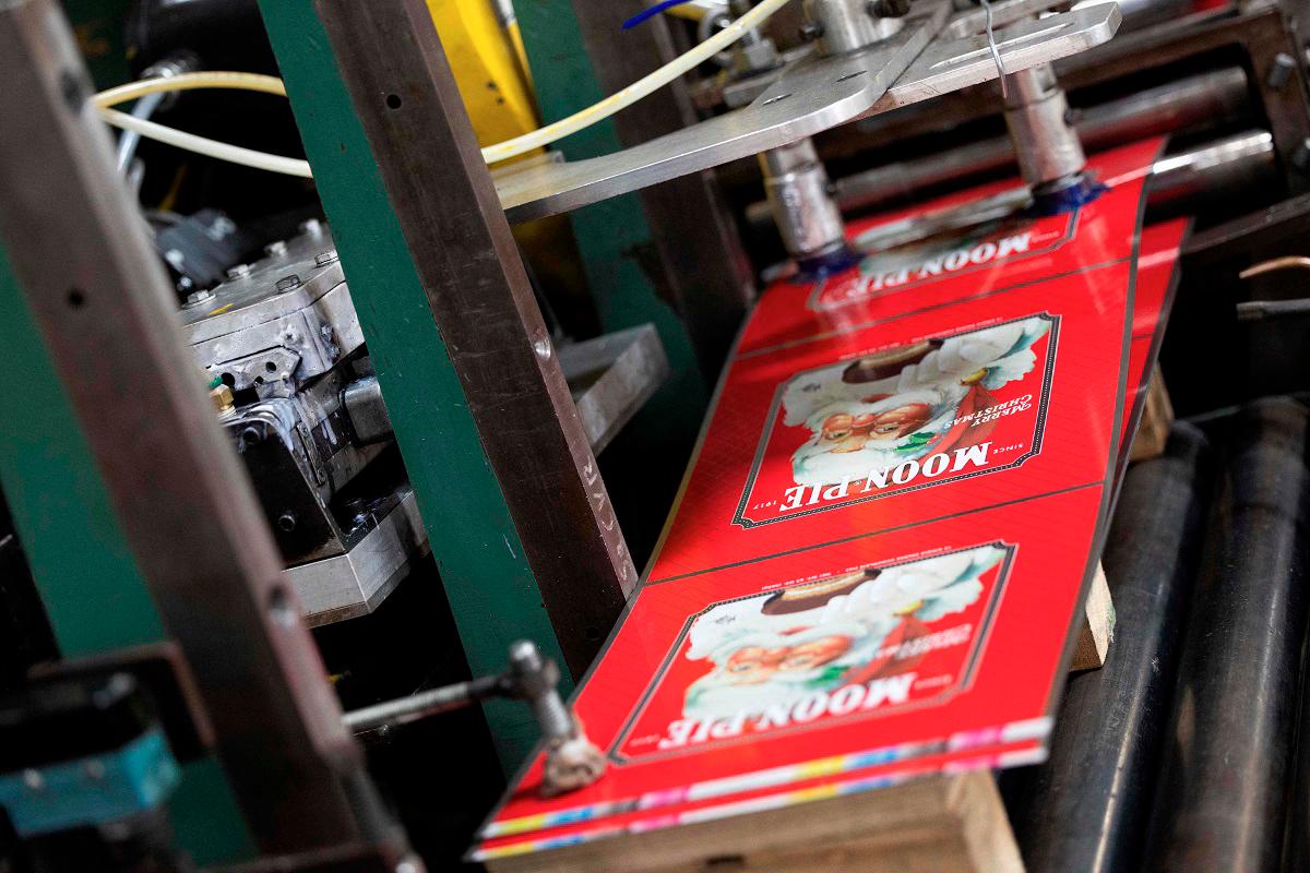 Flat pieces of steel are pulled through a machine where they’ll be shaped into cans for Moon Pies at Independent Can Company’s facilitiy in Belcamp, Maryland, on June 25, 2025. RYAN COLLERD / AFP