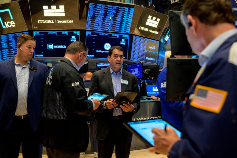 Traders workng on the floor of the New York Stock Exchange on Tuesday, July 25. – AFPpic