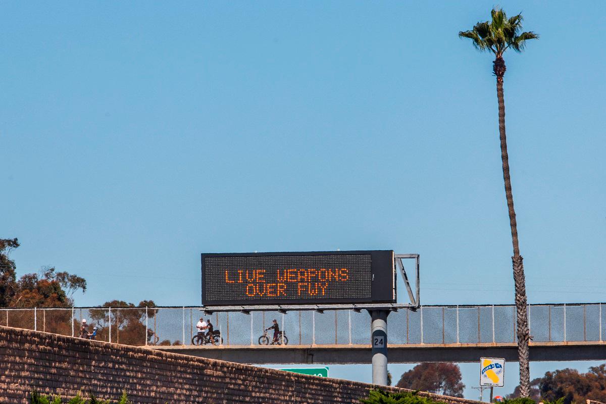 People watch the traffic as signs alert drivers about the closure of the 5 Freeway on October 18, 2025 in San Clemente, California. - Apu Gomes/Getty Images/AFP