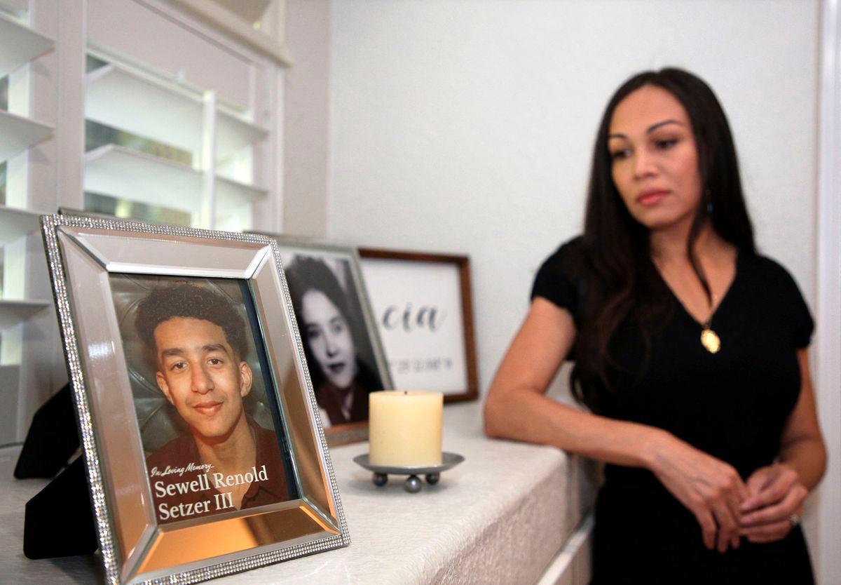 Megan Garcia stands next to a picture of her son Sewell Setzer III at her home in Orlando, Florida on October 9, 2025. (Photo by Gregg Newton / AFP)