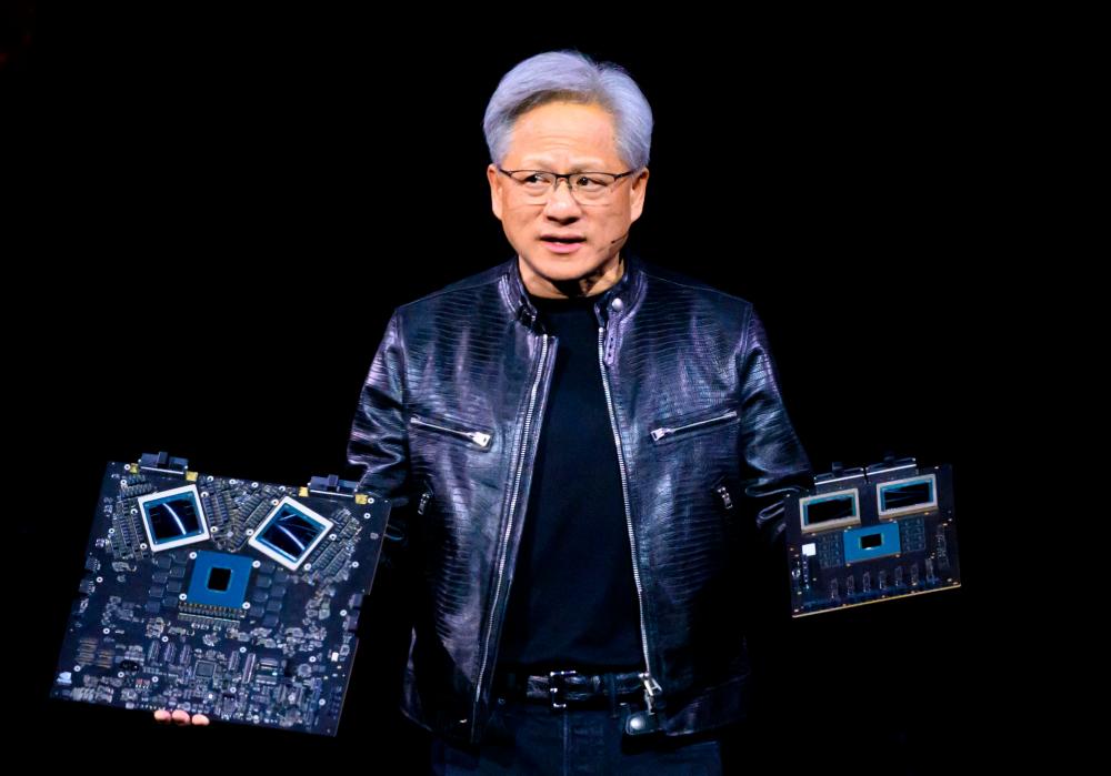 Huang displaying products on stage during the annual Nvidia GTC Artificial Intelligence Conference at SAP Center in San Jose, California, on Monday. – AFPpic