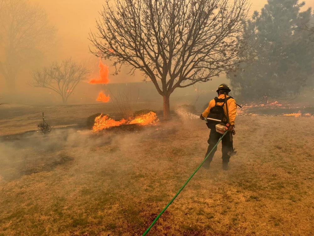 This handout picture courtesy of the Flower Mound Fire Department taken on February 28, 2024, shows a firefighter battling the Smokehouse Creek Fire, near Amarillo, in the Texas Panhandle/AFPPix