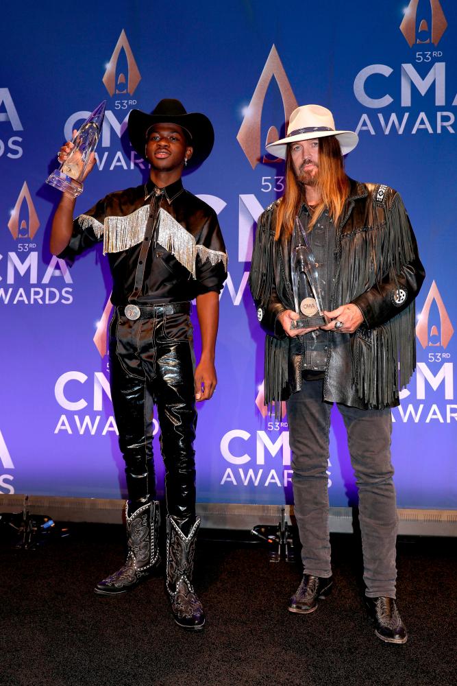 Lil Nas X (L) and Billy Ray Cyrus pose in the press room of the 53rd annual CMA Awards at the Bridgestone Arena on November 13, 2019 in Nashville, Tennessee. Leah Puttkammer/Getty Images/AFP