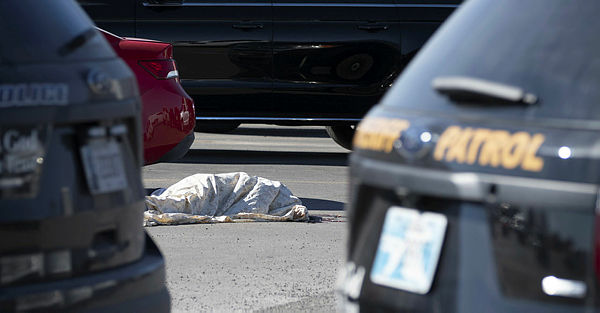 The body of the suspected gunman lays on the ground after a shooting in a Walmart parking lot on Nov 18 2019 — AFP