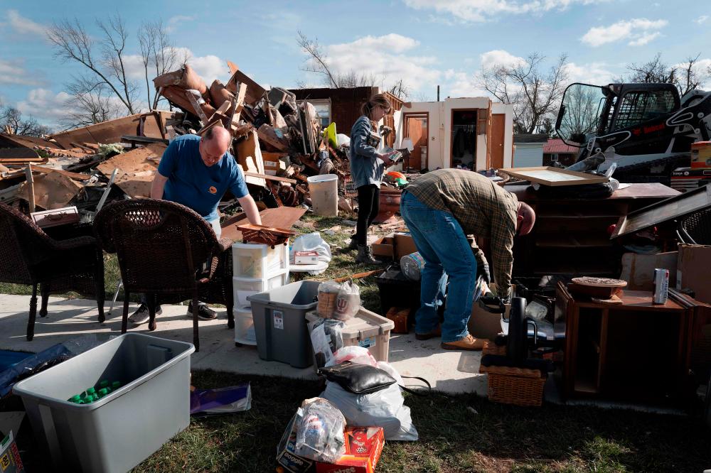 Residents clean up after a tornado ripped through town on March 15, 2024 in Winchester, Indiana/AFPPix