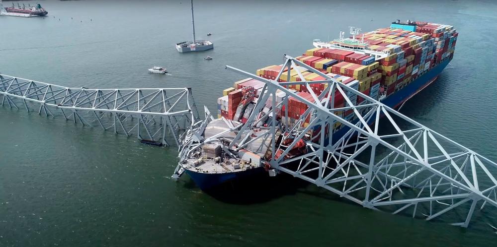 This handout screegrab courtesy of the National Transportation Safety Board taken on March 26, 2028, shows part of the steel frame of the Francis Scott Key Bridge sitting on top of the container ship Dali after the bridge collapsed in Baltimore, Maryland, on March 26, 2024/AFPpix