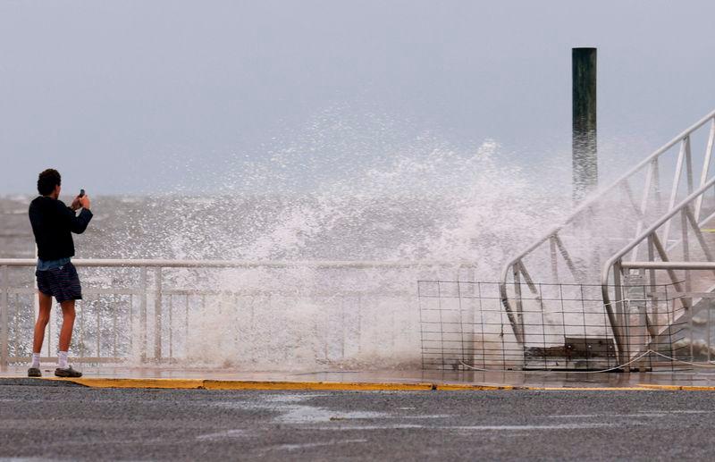 A wave crashes ashore as the region prepares for the possible arrival of Tropical Storm Debby, which is strengthening as it moves through the Gulf of Mexico - AFPpix