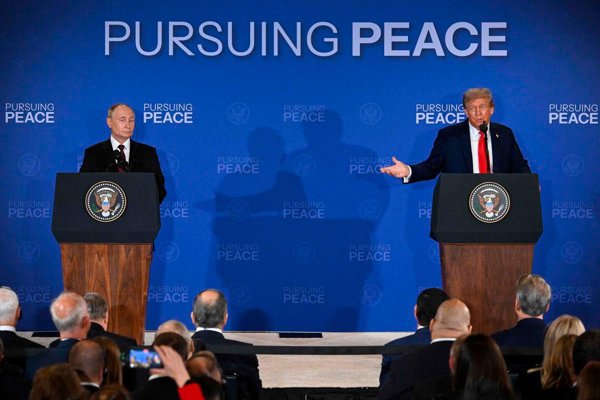 US President Donald Trump (R) gestures toward Russian President Vladimir Putin as they deliver a joint press conference after participating in a US-Russia summit on Ukraine at Joint Base Elmendorf-Richardson in Anchorage, Alaska, on August 15, 2025. (Photo by Drew ANGERER / AFP)