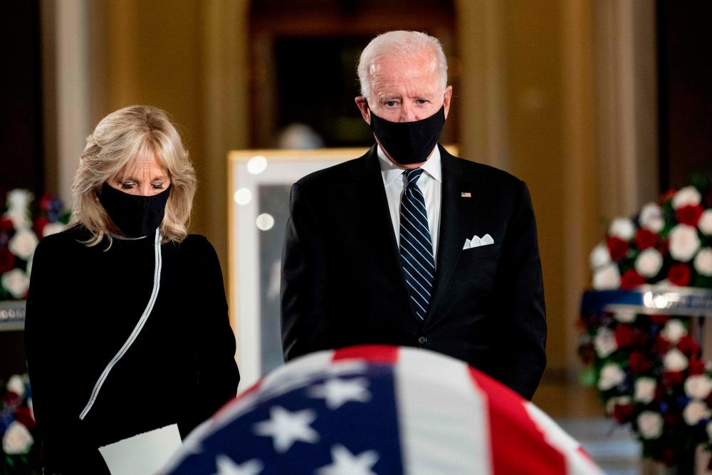Former vice president and Democratic presidential nominee Joe Biden and his wife Jill Biden pay their respects to the late Associate Justice Ruth Bader Ginsburg as her casket lies in state during a memorial service in her honor in the Statuary Hall of the US Capitol in Washington, DC, on September 25, 2020. — AFP