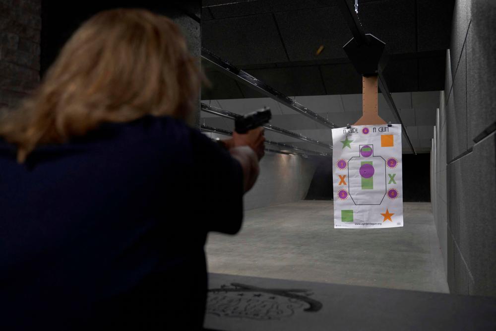 Cindy Scott, a firearms instructor, shoots a handgun at “A Girl and A Gun” shooting target in the shooting range at the Texas Gun Club in League City, Texas, on October 14, 2022. AFPPIX